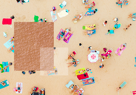 Aerial view of beach with sunbathers with close up of skin texture